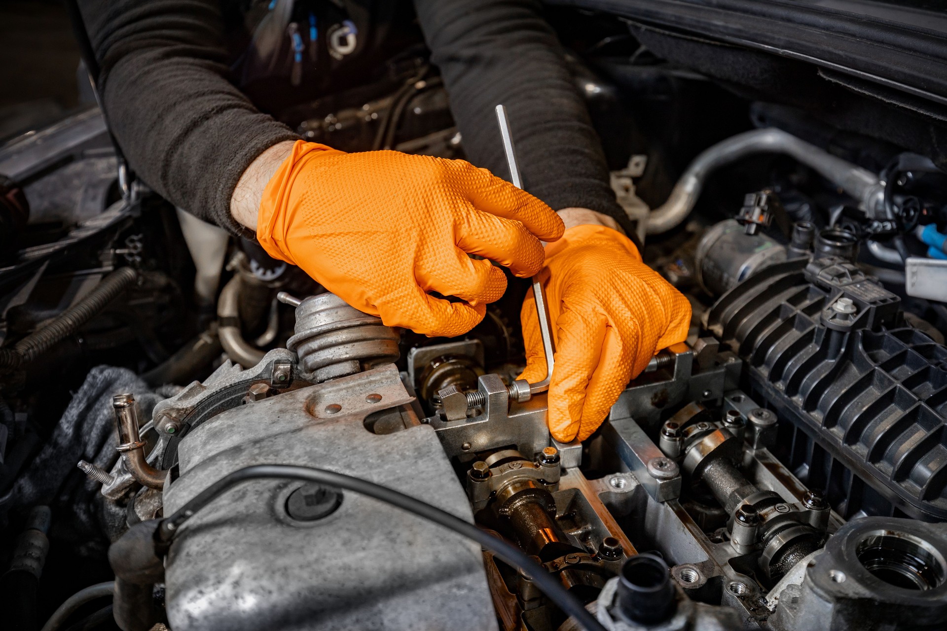 Mechanic Hands Fixing Car Engine in Service